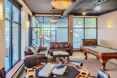 a living room with a pool table at Stonegate Resort Unit B303 in Big White