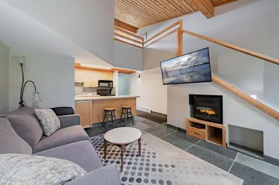 a living room with a couch and a fireplace at Shorewater Resort, Qualicum Beach in Qualicum Beach