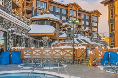 a resort with a pool in the snow at Stonegate Resort Unit B103 in Big White