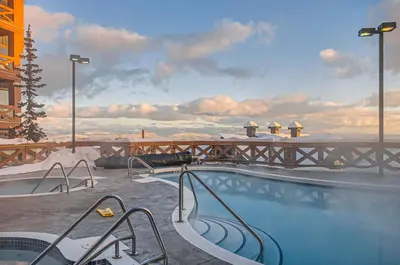 a swimming pool with snow on top of a building at Stonegate Resort Unit C202 in Big White