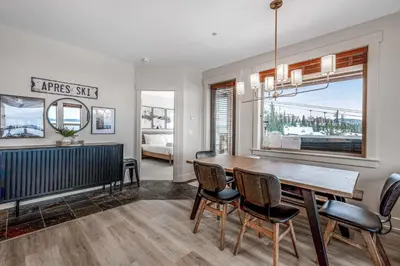 a dining room with a table and chairs at Stonegate Resort Unit C106 in Big White