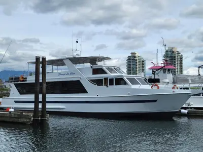 a white boat docked at a dock in the water at Shangri-la Cheer in Vancouver