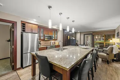 a kitchen with a large island with a counter top at Stylish Family Condo at Beachfront Resort in Parksville