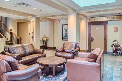 a waiting room with leather chairs and a table at Stonegate Resort Unit B208 in Big White