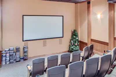 a conference room with a blank screen and a christmas tree at Stonegate Resort Unit A401 in Big White