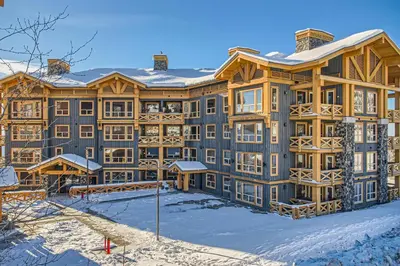 a large building with snow on the ground at Stonegate Resort Unit C304 in Big White