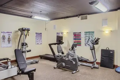 a gym with several treadmills and exercise bikes at Stonegate Resort Unit B108 in Big White