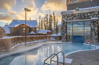 a resort swimming pool with snow on the ground at Stonegate Resort Unit B108 in Big White