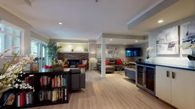 a living room with a kitchen and a living room with a couch at LAGOONS 20 Village location Rare 5BDR Condo With Private Hot Tub in Whistler