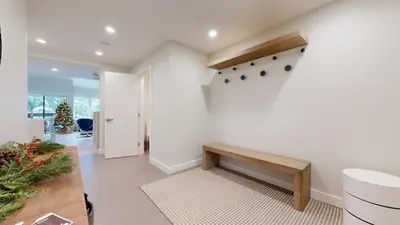 a living room with a bench and a staircase at TELEMARK 25 Ski-In Ski-Out Access Steps To Ski Lifts Renovated Townhome in Whistler