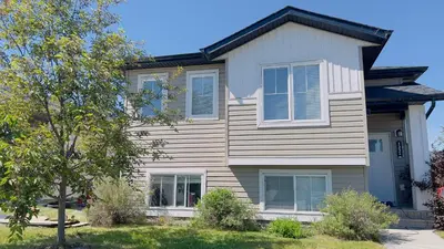 a house with blue shutters on it at Sylvan Lake Retreat I 122A Hinshaw Drive, Sylvan Lake in Sylvan Lake