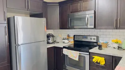 a kitchen with a refrigerator and a stove top oven at Sylvan Lake Retreat I 122A Hinshaw Drive, Sylvan Lake in Sylvan Lake