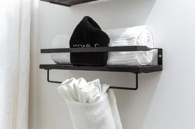 a towel rack with towels on it in a bathroom at Chic & Cozy Loft near Rogers Place, LRT, Jasper Ave in Edmonton