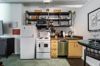 a kitchen with a white refrigerator and a stove at Chic & Cozy Loft near Rogers Place, LRT, Jasper Ave in Edmonton