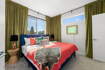 a bedroom with a bed and a large window at Jungle House, AirCon, Sleeps 8, Near WEM & DT! in Edmonton