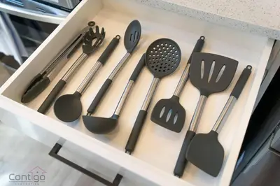 a drawer filled with spatulas and other kitchen utensils at Urban Jungle Getaway, AirCon, 10min to DT & WEM! in Edmonton