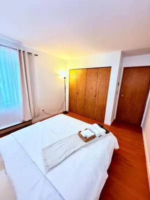 a bedroom with a white bed with two towels on it at Private Room In The Heart Of The City in Vancouver