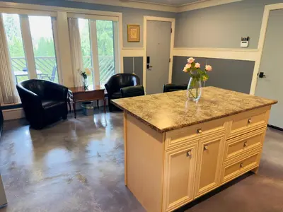 a kitchen with a counter with a vase of flowers on it at Unitrip King bed in Richmond
