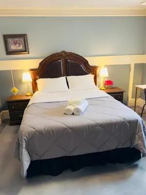 a bedroom with a large bed with two towels on it at Unitrip Queen bed Room 2 in Richmond