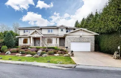 a large white house with a garage at Unitrip Queen bed Room 2 in Richmond
