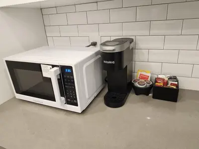 a coffee maker and a microwave on a counter at 2BR Detached Guesthouse - Free Parking -10 mins to YVR & Downtown in Vancouver