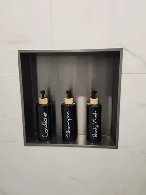 a shelf with three black soap bottles on it at 2BR Detached Guesthouse - Free Parking -10 mins to YVR & Downtown in Vancouver