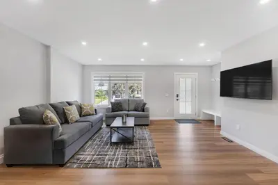 a living room with a couch and a flat screen tv at Your stay at Haysboro in Calgary