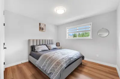 a bedroom with a bed and a window at Your stay at Haysboro in Calgary