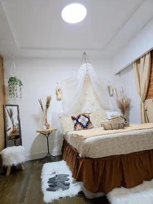 a bedroom with a bed with a mosquito net at Cozy Boho Room at the Heart of Vancouver! Private Parking, Self Check-in & just 4 mins to Metrotown! in Burnaby