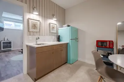 a kitchen with a blue refrigerator and a sink at Luxe Suite close to Spruce Meadows in Priddis