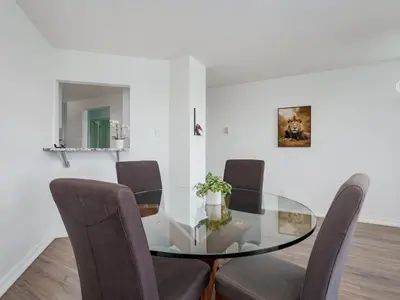 a dining room with a glass table and chairs at Coastal Charm - min 3-Day Stay Breathtaking Views with Work Desk by Victoria Prime! in Victoria