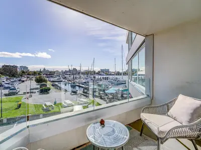 a balcony with a view of a marina at Coastal Charm - min 3-Day Stay Breathtaking Views with Work Desk by Victoria Prime! in Victoria