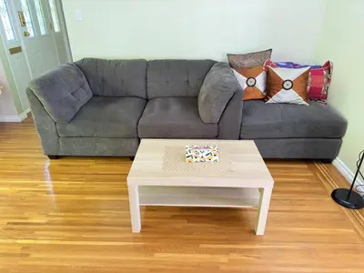 a living room with a couch and a coffee table at Upper floor suite with Garden view near SFU & Skytrain in Coquitlam