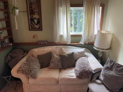 a living room with a couch and a window at Oysterbeds offers our Oyster Suite in Lund