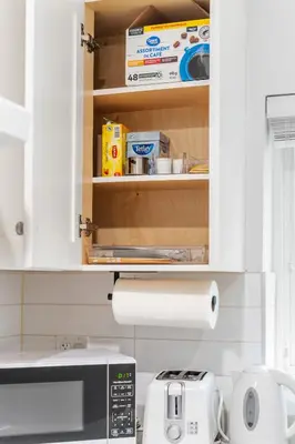a kitchen with a microwave and a roll of paper towels at Cozy and Modern 2br guesthouse in Vancouver