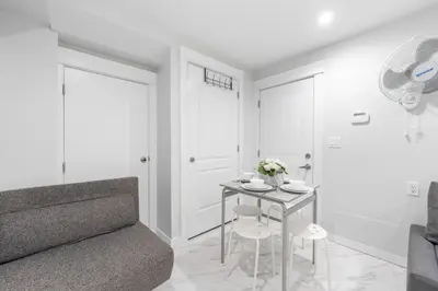a living room with a table and a couch at Cozy and Modern 2br guesthouse in Vancouver