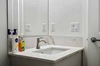 a kitchen with a sink and a white counter top at Perfect Stay 2 Bedroom Basement Suite in Airdrie