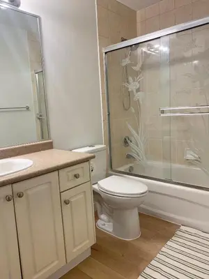 a bathroom with a toilet and a glass shower at Entire 1Bed 1Bath Suite Coquitlam Centre in Port Coquitlam