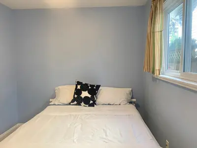 a bed with two pillows on it in a bedroom at Entire 1Bed 1Bath Suite Coquitlam Centre in Port Coquitlam
