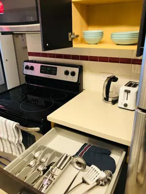a kitchen with a sink and a stove top oven at 5th Floor 1 Bedroom Condo with Parking in Calgary