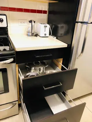 a kitchen with a black refrigerator and a stove at 5th Floor 1 Bedroom Condo with Parking in Calgary