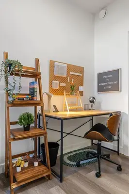 an office with a desk and a ladder and a shelf at Aspen - Town House with 2 Bedrooms, Garage Parking, AC & More! in Calgary
