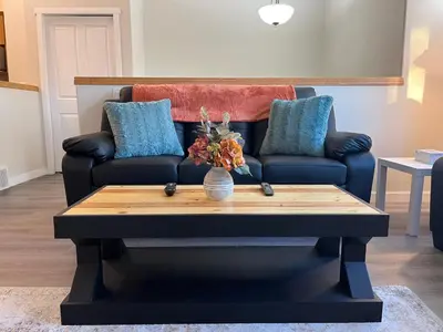 a living room with a couch and a coffee table at Park View Paradise - Big, Bright, Modern, Fully Stocked in Grande Prairie