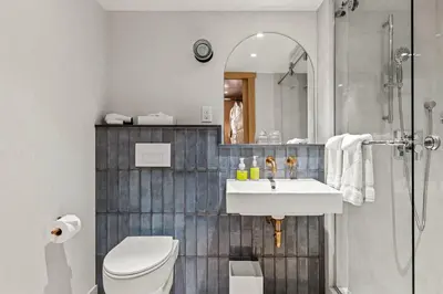 a bathroom with a toilet and a sink and a shower at Otter Hotel in Banff