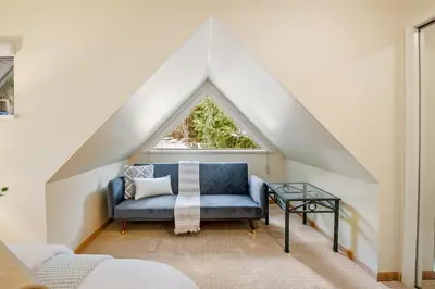 a room with a blue couch and a window at 31 GlenEagle in Whistler