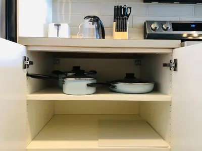 a kitchen with two pots and pans on a shelf at 7th Floor 1 Bedroom Condo with Parking in Calgary