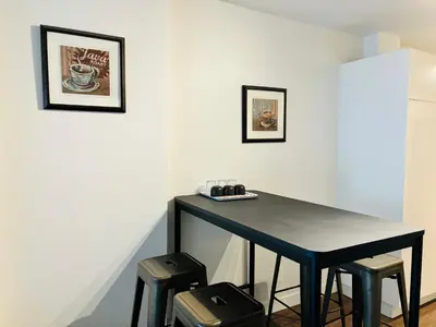 a black table and stools in a room at 7th Floor 1 Bedroom Condo with Parking in Calgary