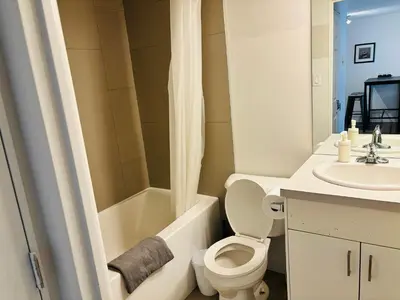 a bathroom with a toilet and a sink at 7th Floor 1 Bedroom Condo with Parking in Calgary