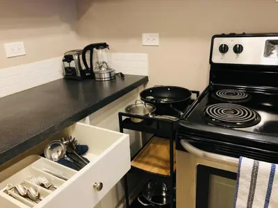 a kitchen with a stove and a sink at 6th Floor 2 Bedroom Condo with Parking in Calgary