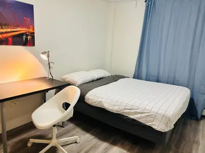 a bedroom with a bed and a desk and a chair at Cozy 1 Bedroom Condo with Parking in Calgary